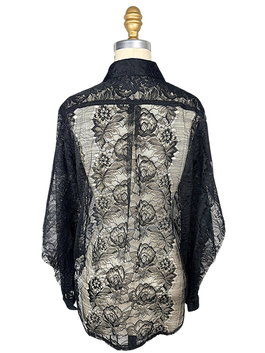 Back view of Comme des Garçons black sheer floral lace button-down shirt displaying intricate botanical lace and back yoke detailing.