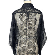 Back view of Comme des Garçons black sheer floral lace button-down shirt displaying intricate botanical lace and back yoke detailing.