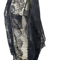 Close-up of Comme des Garçons black floral lace shirt showing chest patch pocket, button placket and delicate transparent botanical lace.