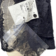 Comme des Garçons black floral lace shirt with Japanese garment care label, style code GJ-B008 and accompanying spare lace fabric.