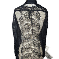 Back of Comme des Garçons black sheer floral lace shirt on dress form, showing floral pattern, collar and original designer label.