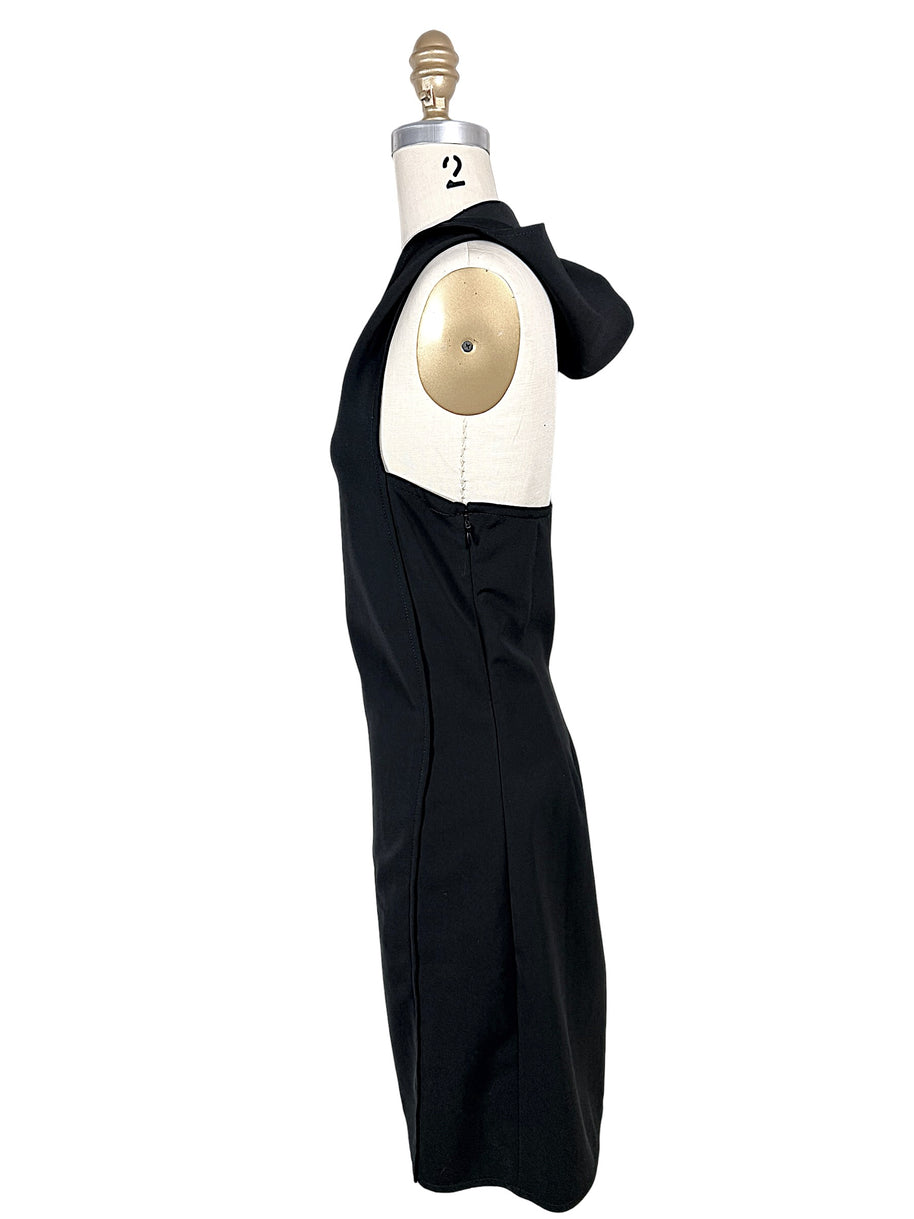 Courrèges Fall 2024 Look 23 black hooded mini dress photographed from the opposite side, displaying sculptural hood, open side and concealed zipper closure.