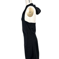 Courrèges Fall 2024 Look 23 black hooded mini dress photographed from the opposite side, displaying sculptural hood, open side and concealed zipper closure.