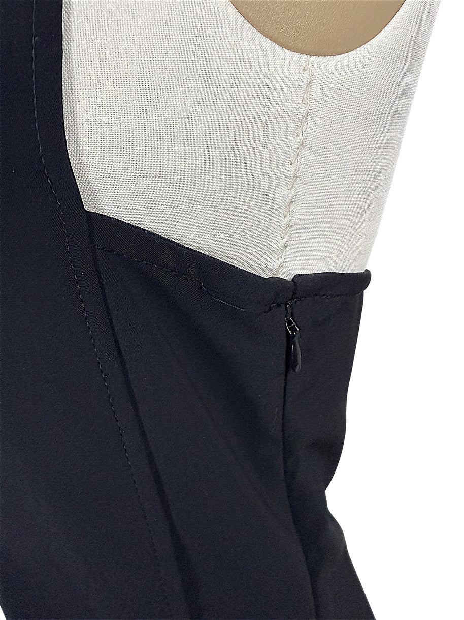 Close-up of Courrèges Fall 2024 Ready-to-Wear Look 23 black hooded mini dress showing loose threading beneath the arm near the concealed side zipper, photographed for condition reference.