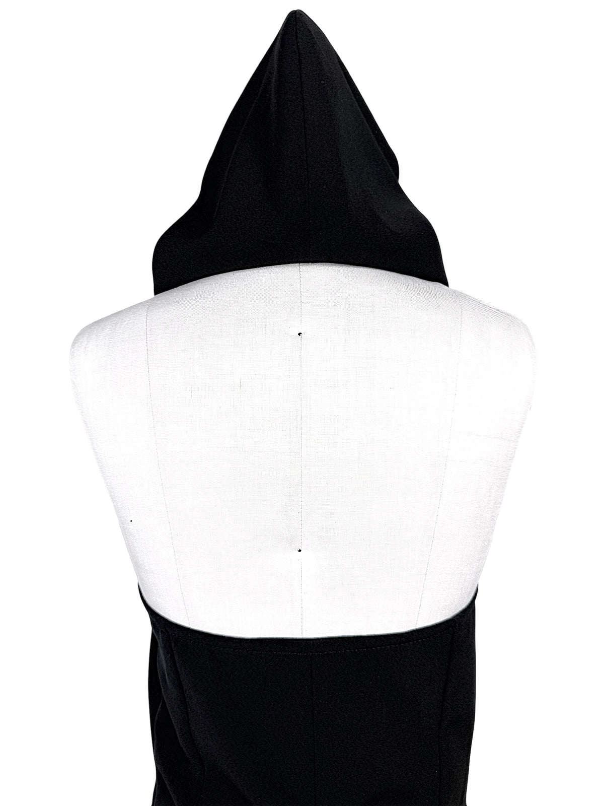 Courrèges Fall 2024 Ready-to-Wear Look 23 black Oblique Space hooded mini dress, close-up rear view highlighting sculptural pointed hood and open-back construction.