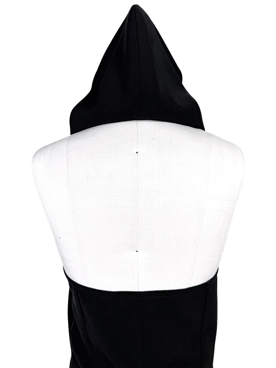 Courrèges Fall 2024 Ready-to-Wear Look 23 black Oblique Space hooded mini dress, close-up rear view highlighting sculptural pointed hood and open-back construction.