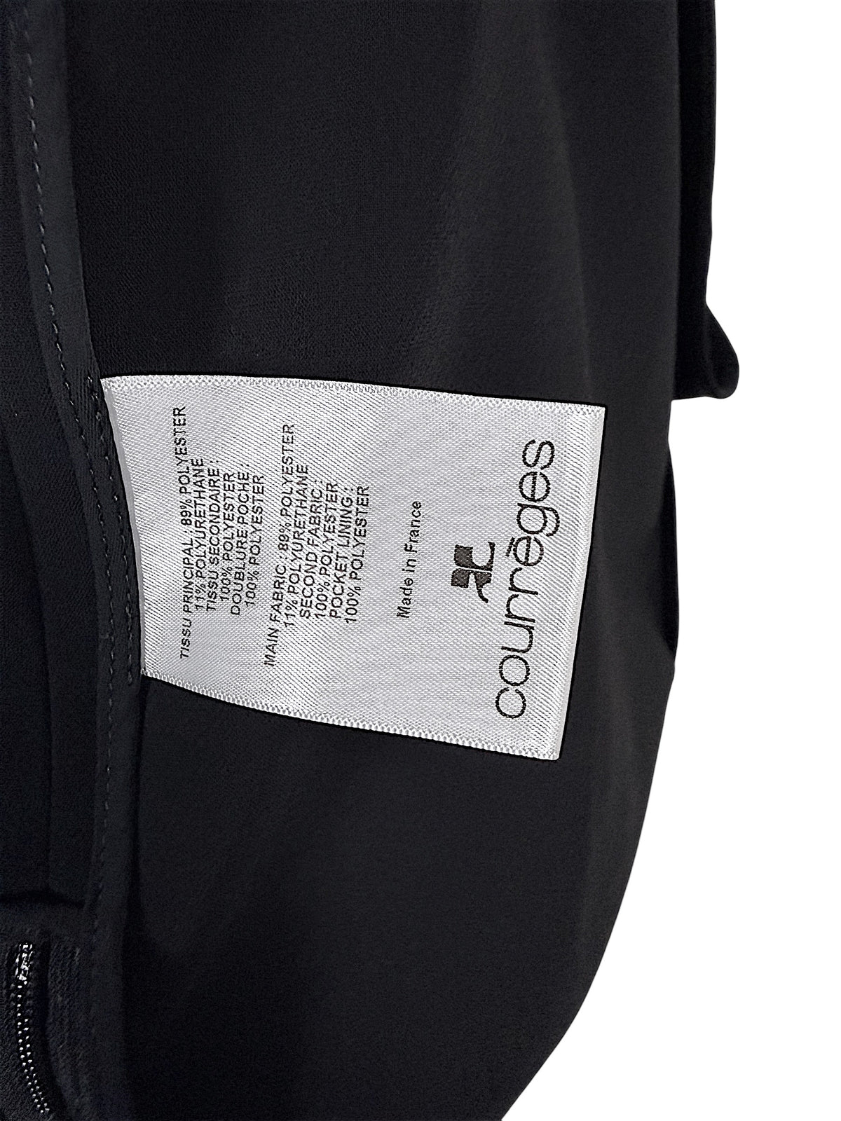 Courrèges Fall 2024 Look 23 black mini dress interior composition label showing 89% polyester, 11% elastane main fabric and Made in France origin.