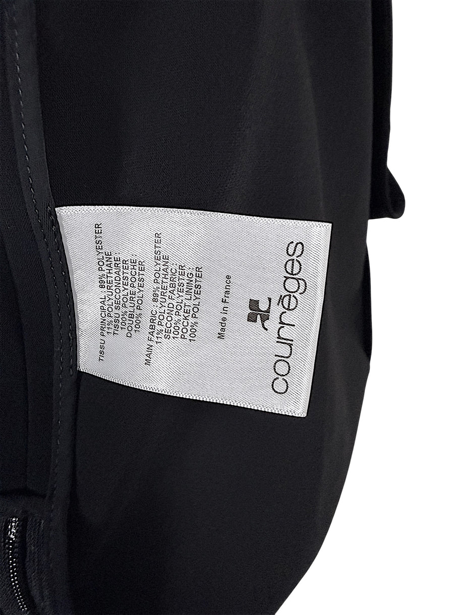 Courrèges Fall 2024 Look 23 black mini dress interior composition label showing 89% polyester, 11% elastane main fabric and Made in France origin.