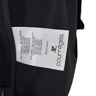 Courrèges Fall 2024 Look 23 black mini dress interior composition label showing 89% polyester, 11% elastane main fabric and Made in France origin.