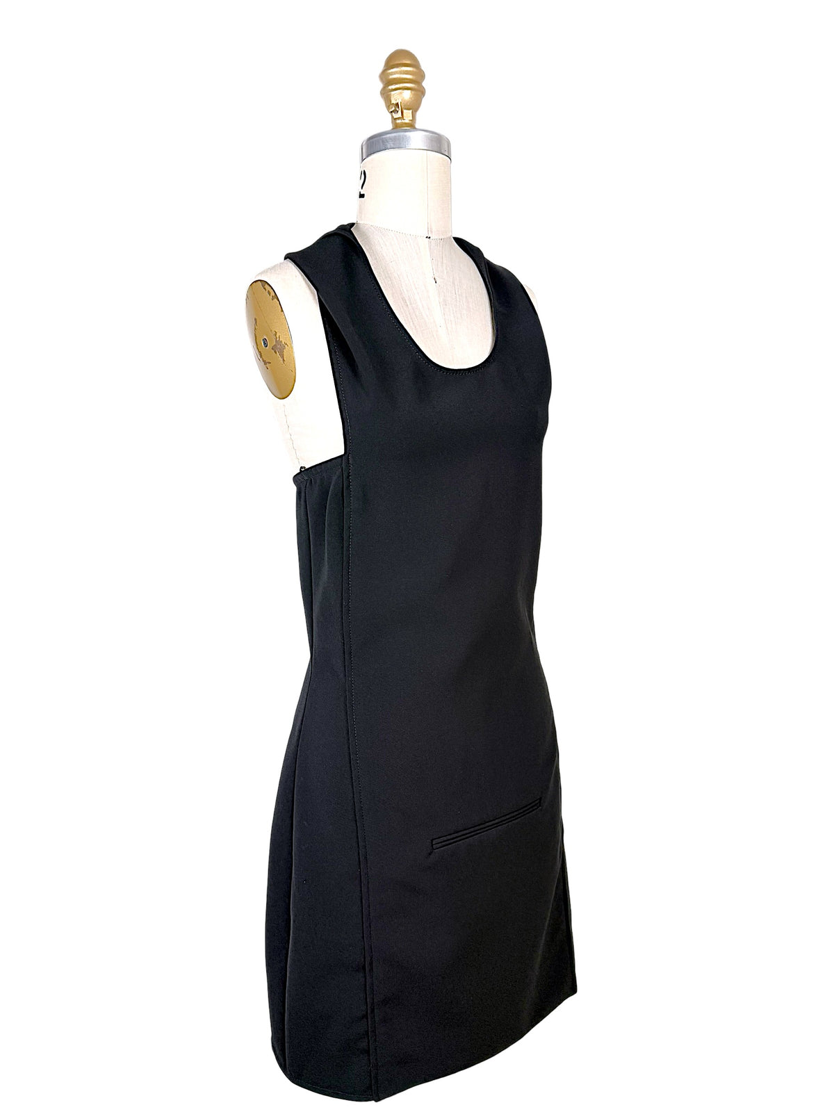 Three-quarter front view of Courrèges Fall 2024 black Oblique Space sleeveless mini dress showing fitted silhouette, scoop neckline and tailored side seams.