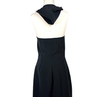 Back view of Courrèges Fall 2024 Oblique Space mini dress with hood lowered, showing the exposed upper back, tailored waist and structured black skirt.