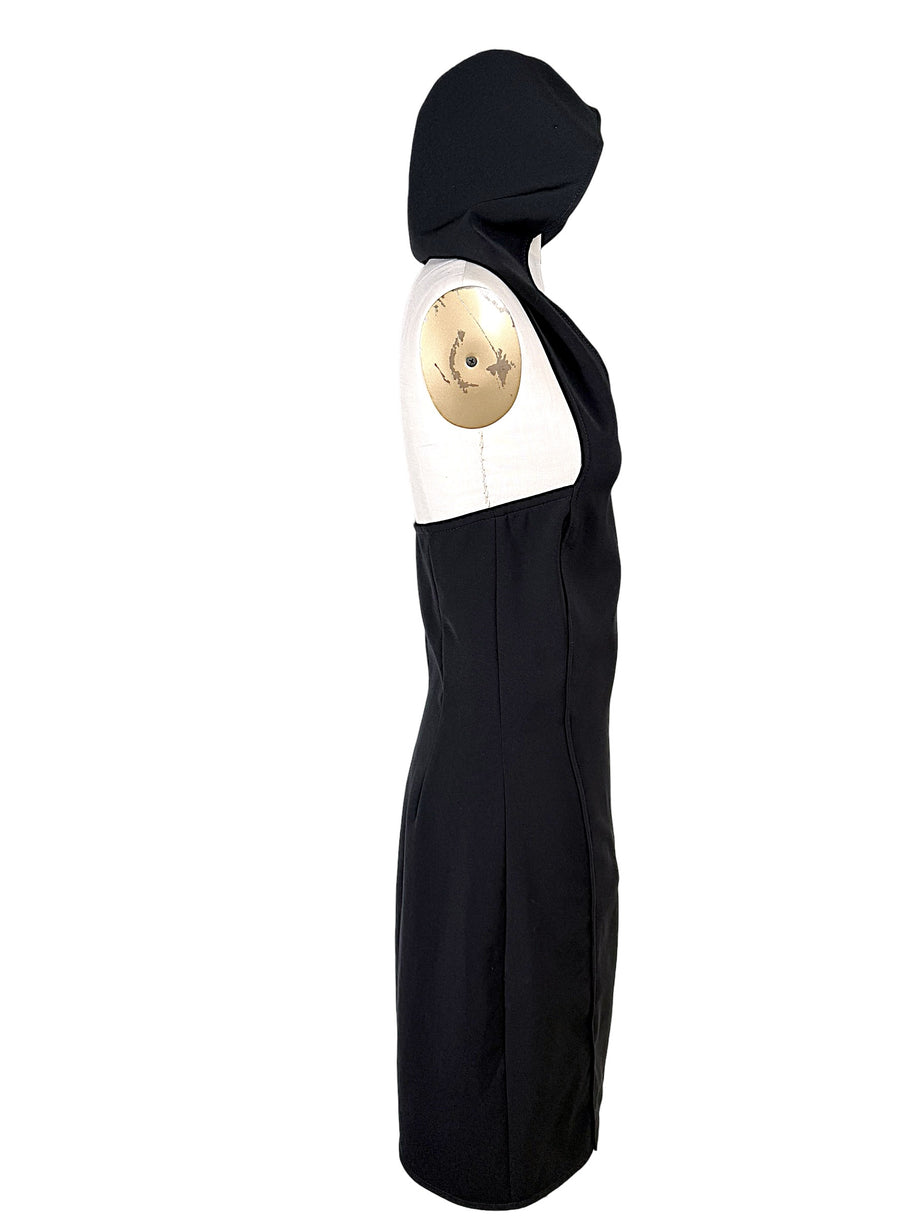 Side view of Courrèges Fall 2024 Look 23 Oblique Space black hooded mini dress highlighting its open-back construction, contoured seams and mini-length hem.