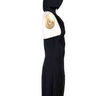 Side view of Courrèges Fall 2024 Look 23 Oblique Space black hooded mini dress highlighting its open-back construction, contoured seams and mini-length hem.
