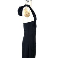 Side profile of Courrèges Fall 2024 Oblique Space black mini dress with hood lowered, revealing the dramatic open upper back and fitted side construction.