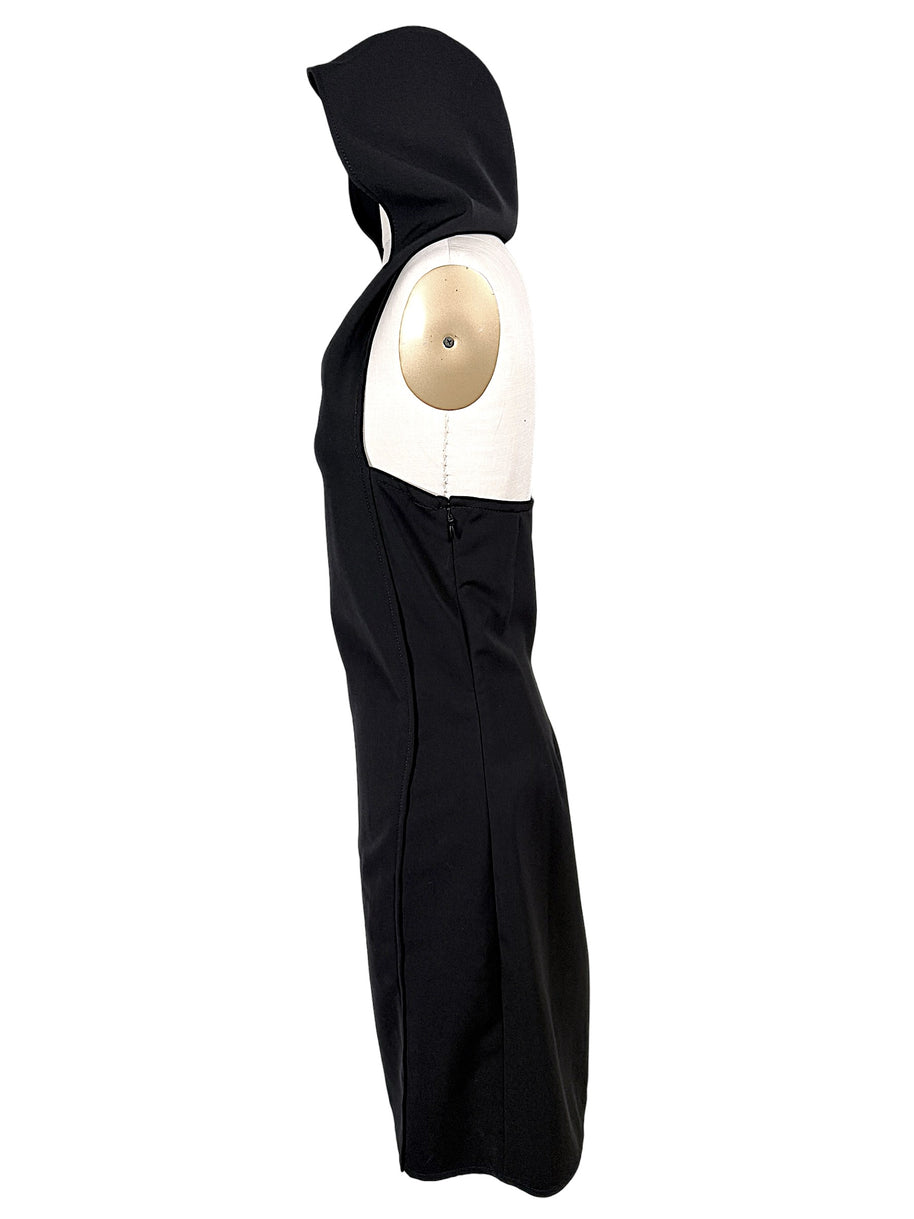 Side profile of Courrèges Fall 2024 Look 23 black Oblique Space mini dress on US size 2 mannequin, showing raised hood, sleeveless cut and fitted silhouette.
