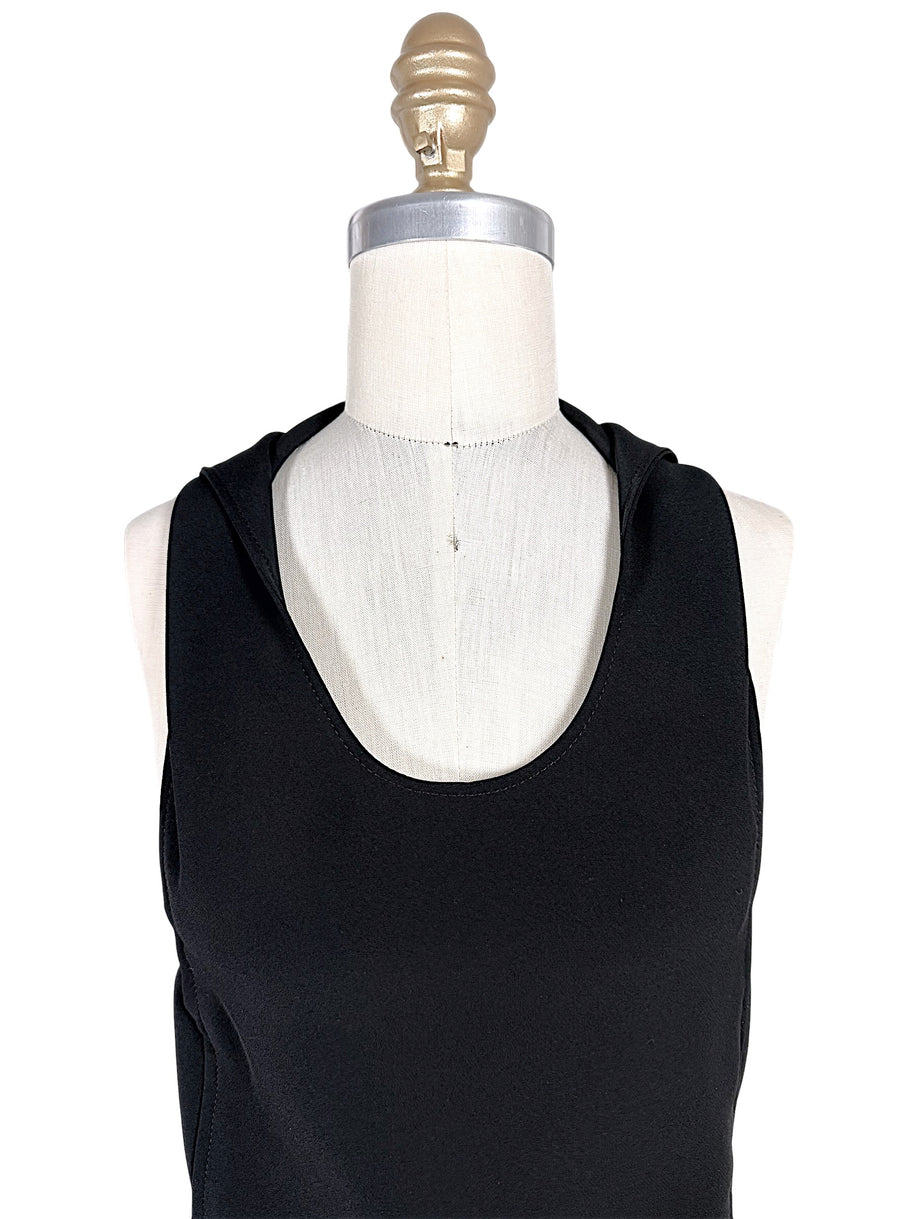 Close-up of Courrèges Fall 2024 Look 23 Oblique Space black mini dress showing smooth technical stretch fabric, sleeveless shoulders and rounded scoop neckline.