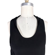 Close-up of Courrèges Fall 2024 Look 23 Oblique Space black mini dress showing smooth technical stretch fabric, sleeveless shoulders and rounded scoop neckline.