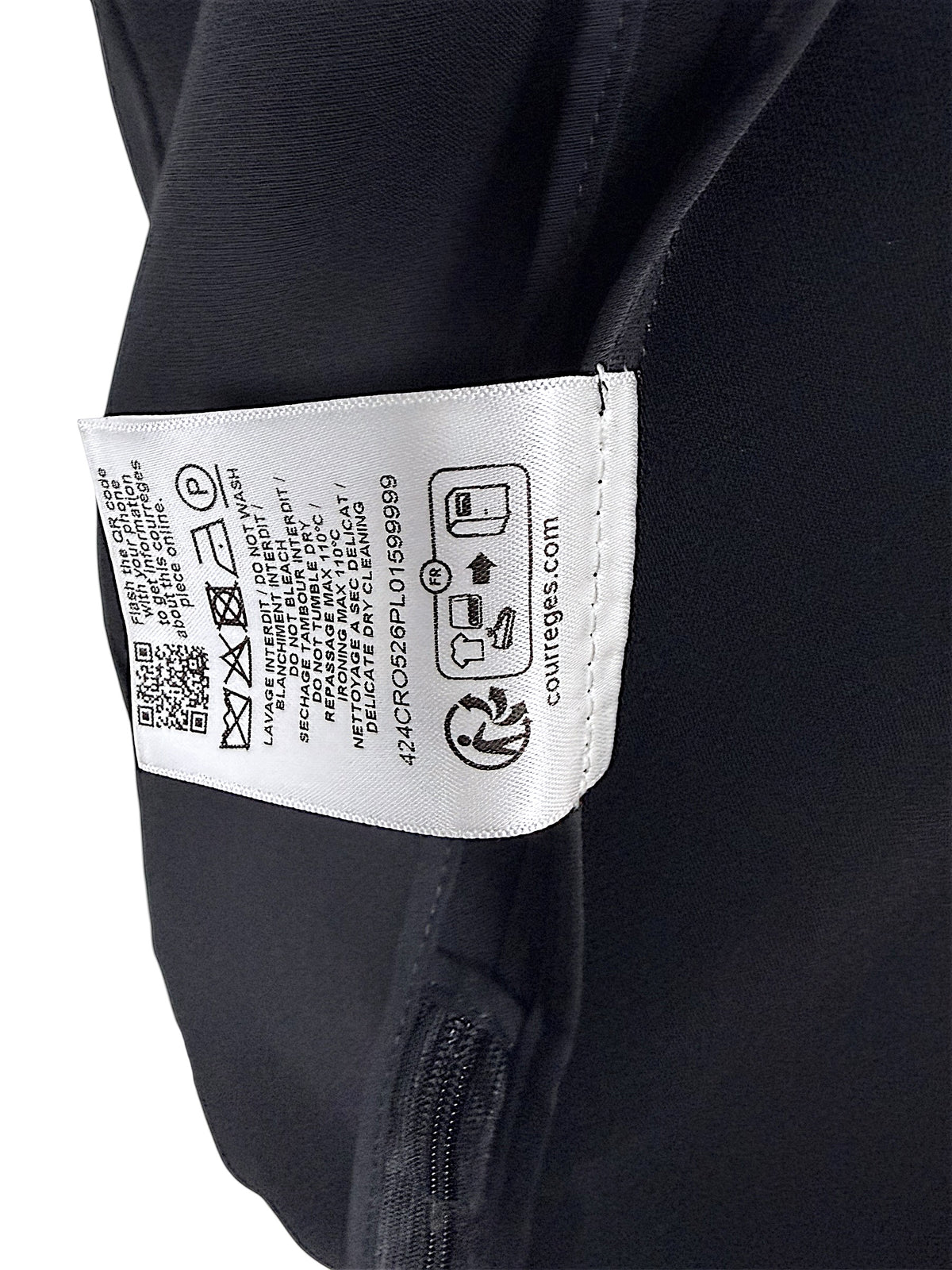 Interior care instruction label of Courrèges Fall 2024 Look 23 black Oblique Space hooded mini dress, displaying washing instructions and garment reference code 424CR0526PL0159999.