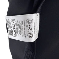 Interior care instruction label of Courrèges Fall 2024 Look 23 black Oblique Space hooded mini dress, displaying washing instructions and garment reference code 424CR0526PL0159999.