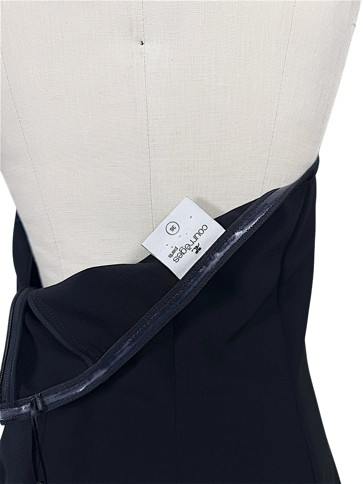 Authentic Courrèges Paris designer label showing French size 36 inside Fall 2024 Look 23 Oblique Space black hooded mini dress, with interior construction visible.