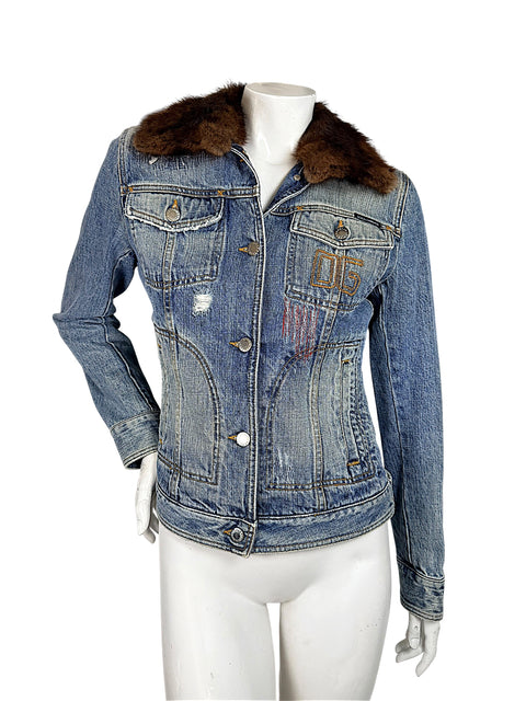 Front view of vintage Dolce & Gabbana fitted blue denim jacket with chocolate-brown fur collar, distressed wash, embroidered 05 motif, and branded buttons.