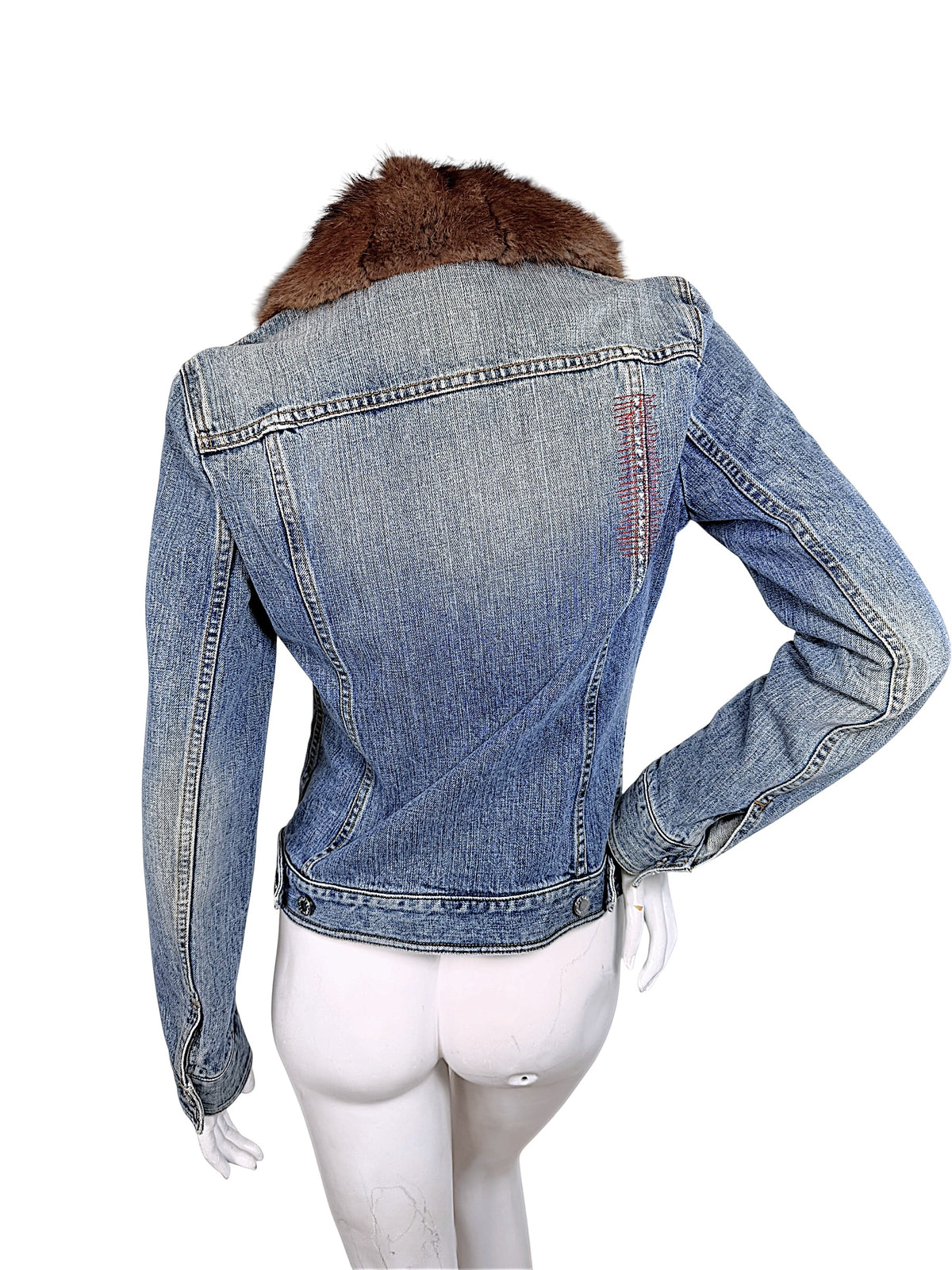Rear view of vintage Dolce & Gabbana denim jacket featuring fitted back panel seams, faded blue cotton denim, red stitching, and brown fur collar.