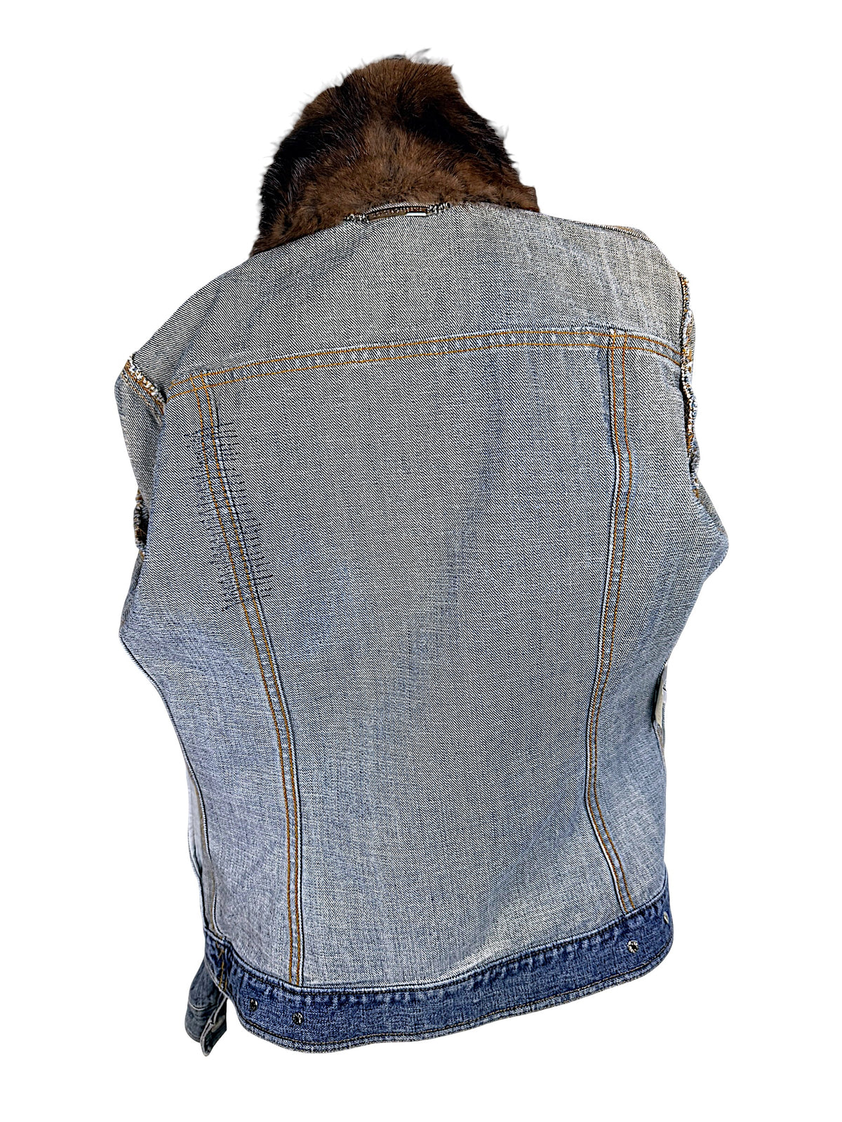Interior back of Dolce & Gabbana vintage denim jacket showing cotton twill construction, golden seam stitching, shaped panels, and brown fur collar.