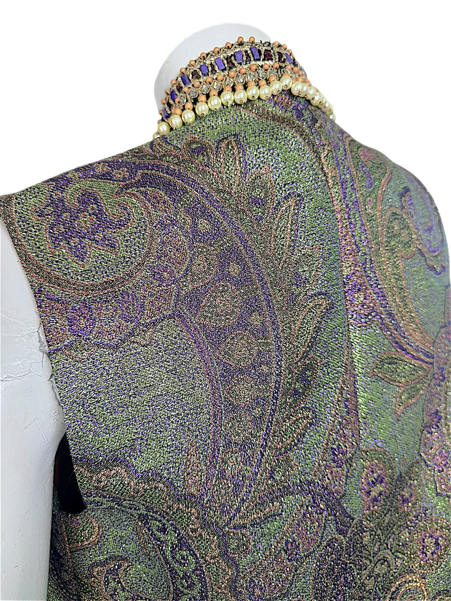 Close-up of Etro vest back showing intricate metallic paisley jacquard weave and raised collar with faux pearls and purple beading.