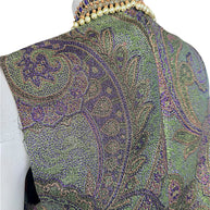 Close-up of Etro vest back showing intricate metallic paisley jacquard weave and raised collar with faux pearls and purple beading.