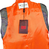 Close-up of Etro Made in Italy designer label and original paisley-patterned retail hangtag against bright orange vest lining.