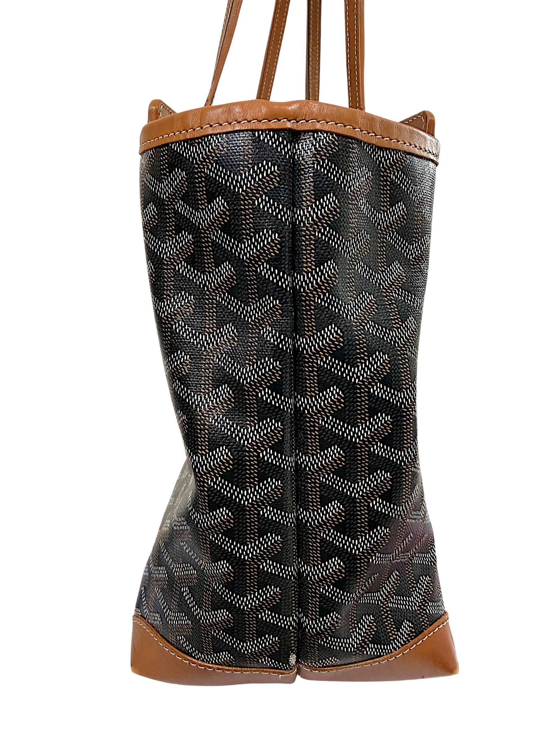 Right side profile view of authentic Goyard Artois PM tote with black Goyardine canvas and tan leather trim.