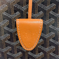 Close-up of Goyard Artois PM leather clochette showing natural indentations and wear consistent with use.