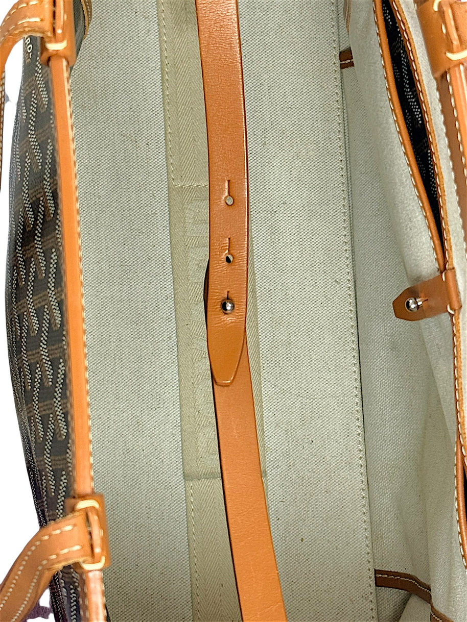 Close-up detail of Goyard Artois PM leather closure strap and interior fastening hardware.