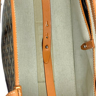 Close-up detail of Goyard Artois PM leather closure strap and interior fastening hardware.