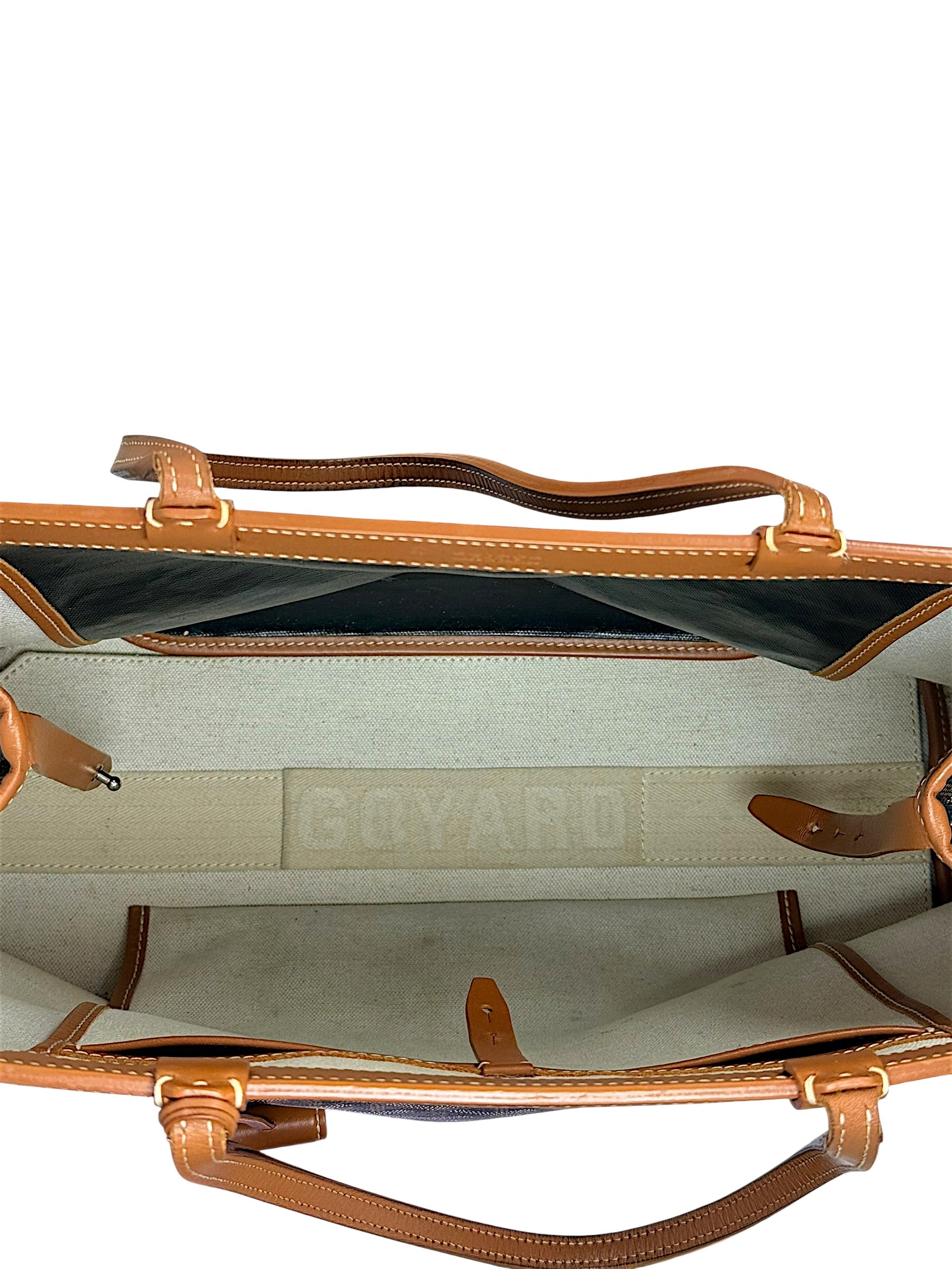 Interior side compartment detail of authentic Goyard Artois PM handbag showing canvas and leather construction.