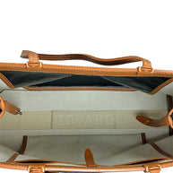 Interior side compartment detail of authentic Goyard Artois PM handbag showing canvas and leather construction.