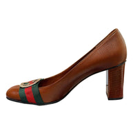 Side profile view of Gucci brown leather block heel pumps with iconic Web stripe detailing and interlocking GG hardware.