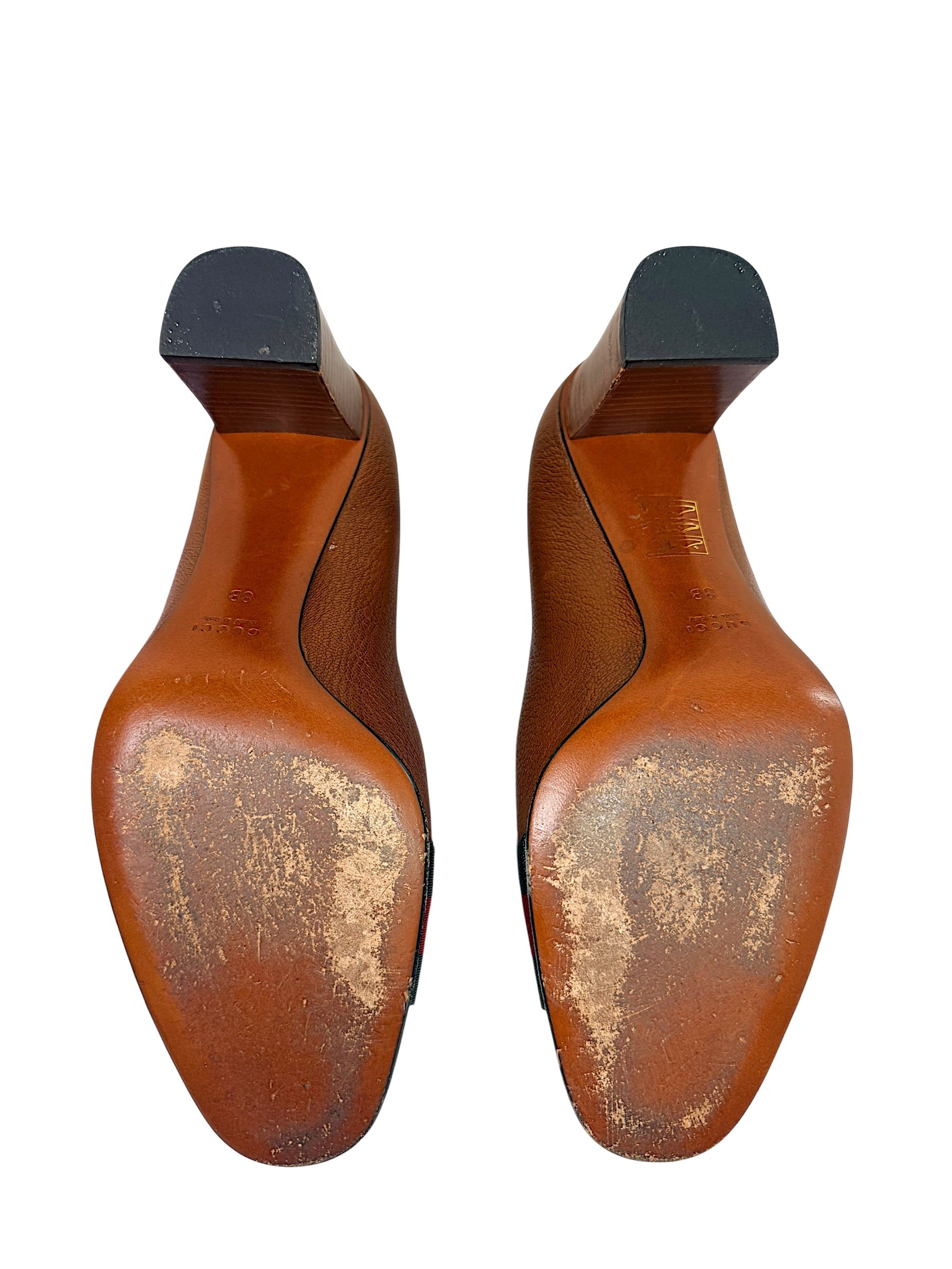 Bottom sole view of authentic Gucci leather pumps showing wear consistent with normal age and use.