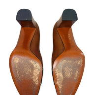 Bottom sole view of authentic Gucci leather pumps showing wear consistent with normal age and use.