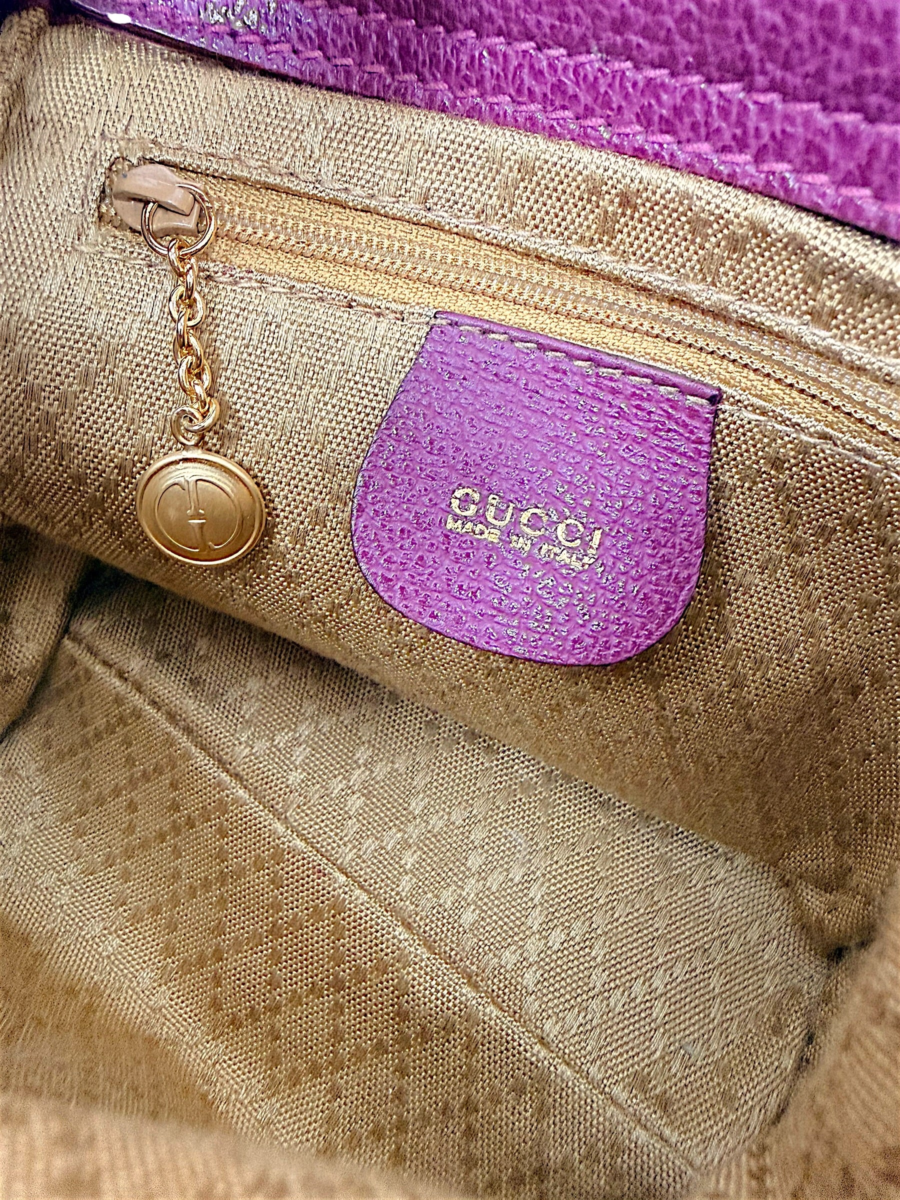Interior zip pocket and Gucci logo charm inside vintage bamboo bag