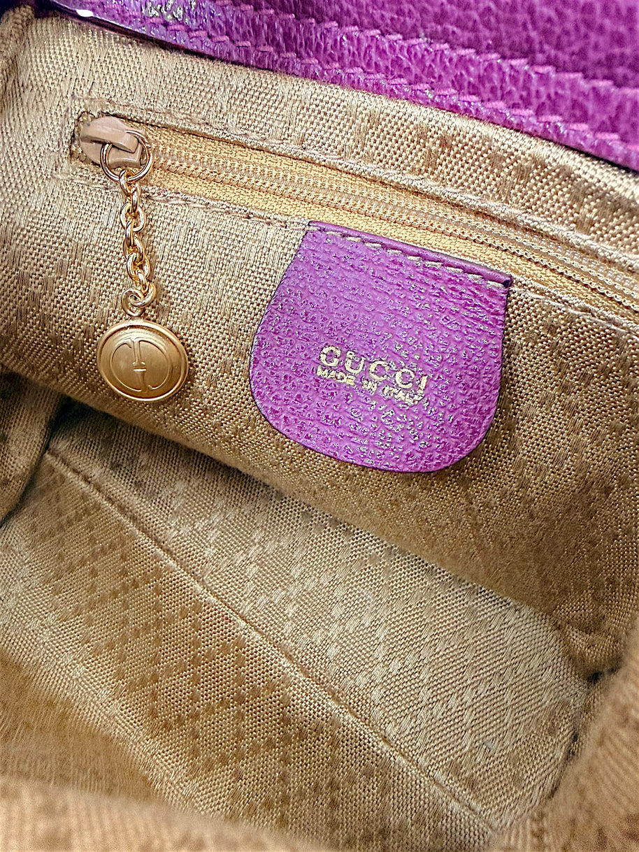 Interior zip pocket and Gucci logo charm inside vintage bamboo bag