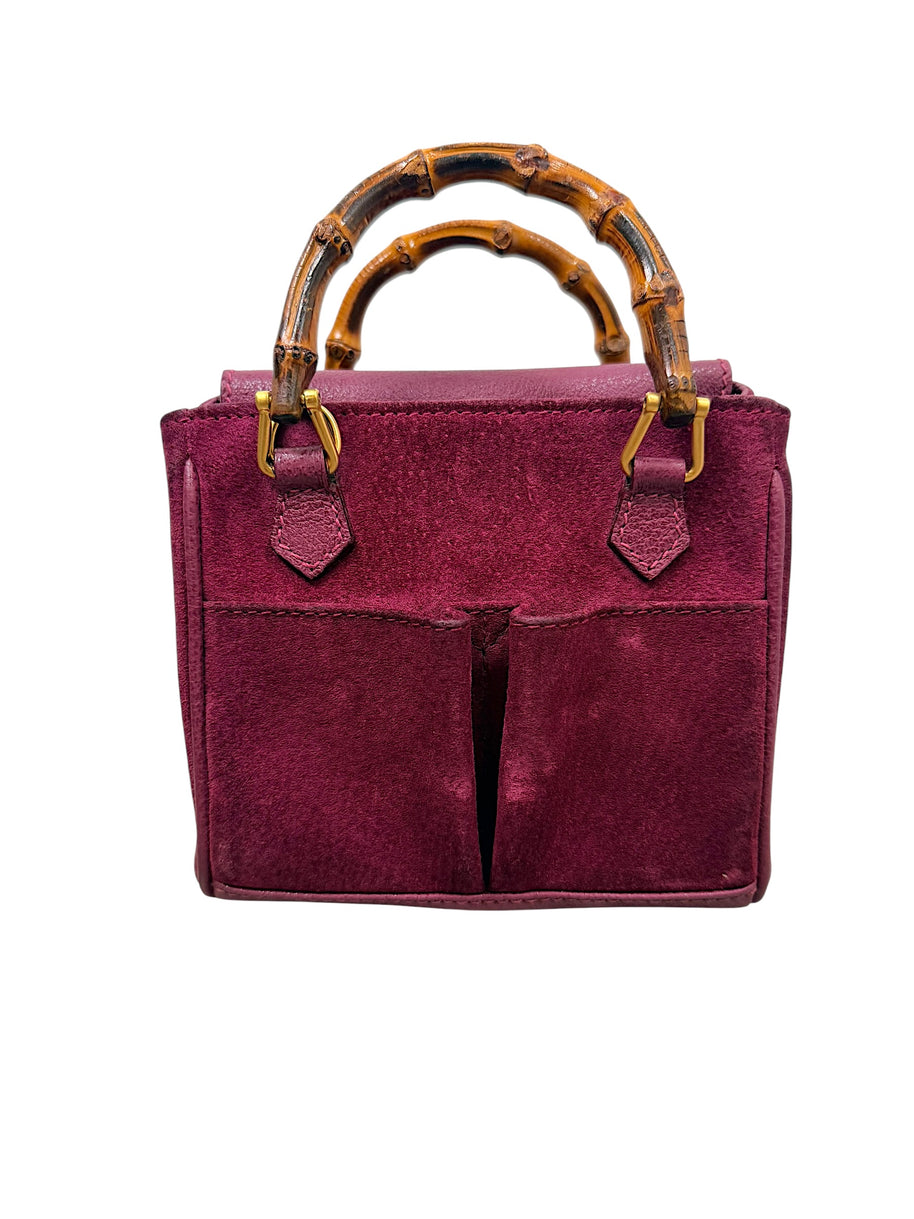 Front view of vintage Gucci magenta suede bamboo handle handbag