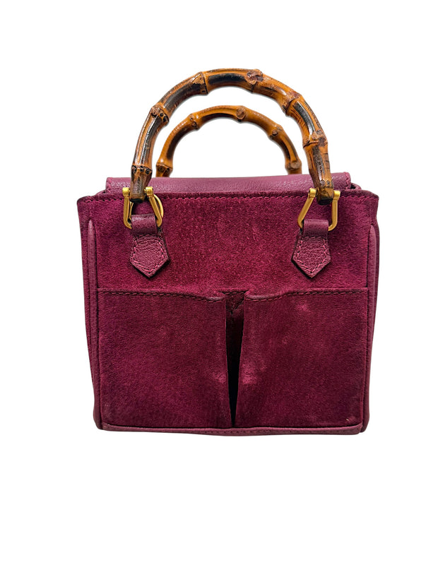 Front view of vintage Gucci magenta suede bamboo handle handbag