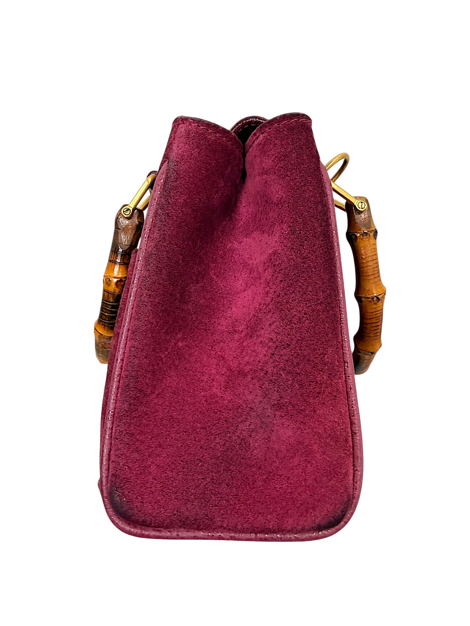 Left side profile of Gucci bamboo handle suede mini bag
