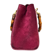 Left side profile of Gucci bamboo handle suede mini bag
