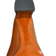 Close-up detail of Gucci block heel and leather sole construction showing heel cap and condition.