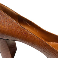 Close-up interior view showing Gucci size marking EU 38B and pebbled brown leather construction.