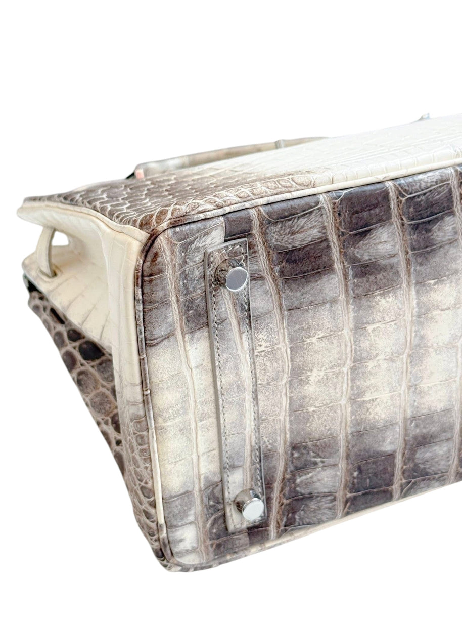 Base underside detail of Hermès Himalaya Niloticus Crocodile Birkin 30 with protective feet and structured construction.