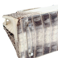 Base underside detail of Hermès Himalaya Niloticus Crocodile Birkin 30 with protective feet and structured construction.