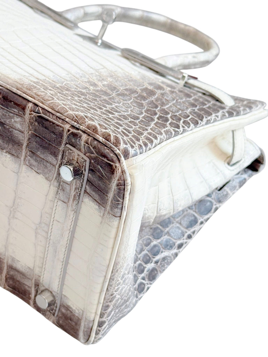 Bottom corner detail of Hermès Himalaya Birkin 30 showing crocodile scale pattern and protective feet hardware.